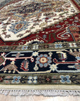 Cozy Harlow Navy Hand Knotted Wool Rug, deep navy tones swirling in a soft, textural hand-knotted wool construction, enriching a warmly lit living space with subtle patterns and inviting comfort.