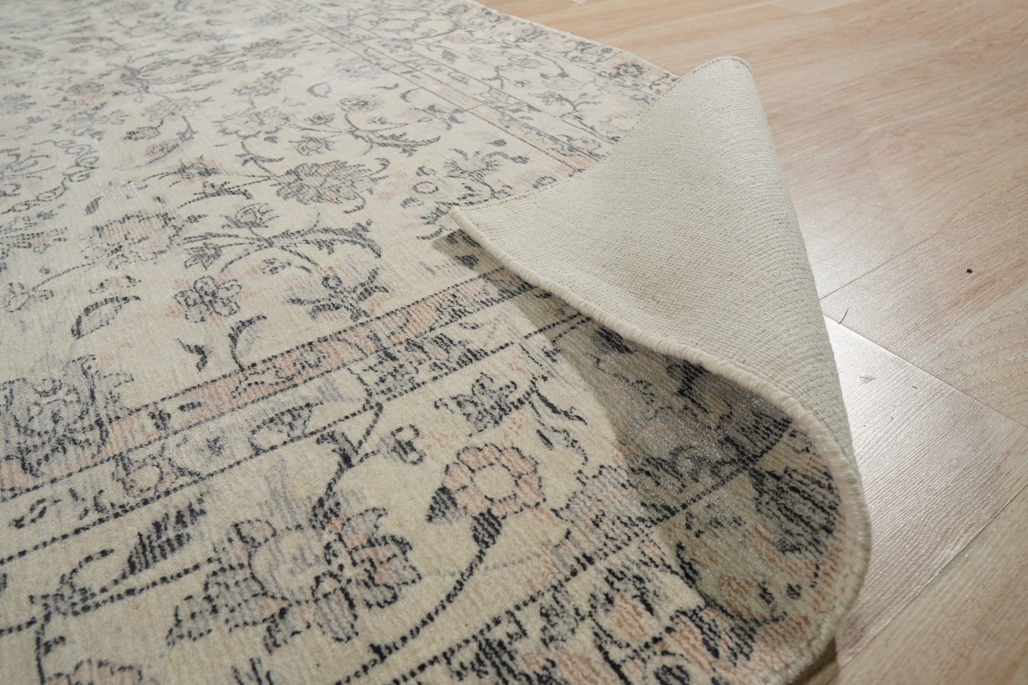 Sleek Rustic Beige Handmade Wool Rug, displaying warm beige tones and subtle texture across a living room floor, offering a soft, hand-woven grounding element.
