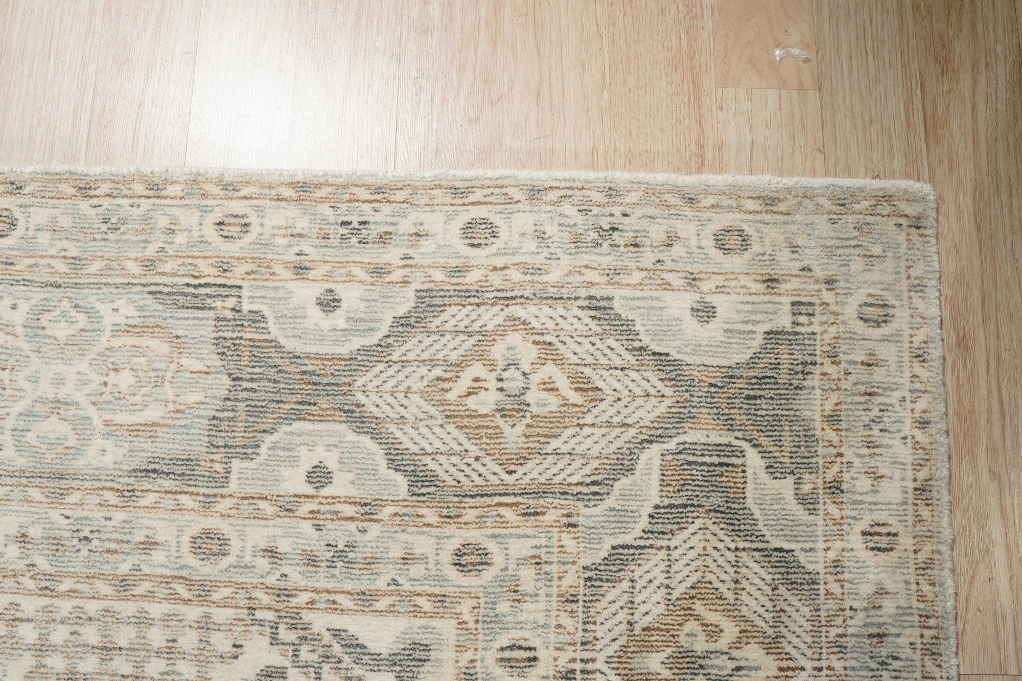 Tessa Bespoke Green Handmade Wool Rug, showcasing vibrant green hues and handcrafted wool texture, elegantly displayed on a light wood floor in a well-lit room.