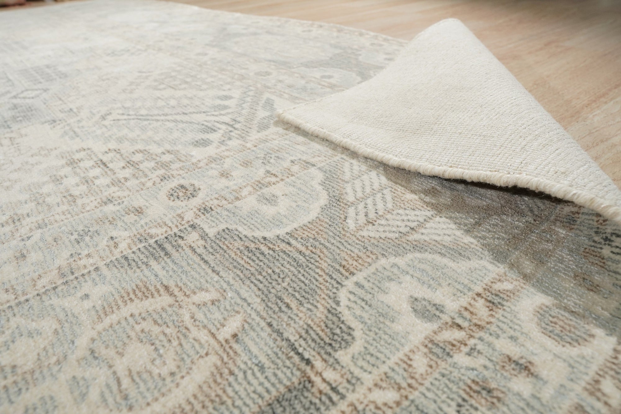 Tessa Bespoke Green Handmade Wool Rug, a lush emerald expanse crafted from wool, anchors a bright living room with a geometric textured design.