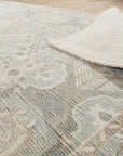 Tessa Bespoke Green Handmade Wool Rug, a lush emerald expanse crafted from wool, anchors a bright living room with a geometric textured design.