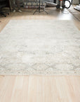 Tessa Bespoke Green Handmade Wool Rug, a lush verdant expanse of hand-knotted wool, lies on a light wood floor, its texture subtly catching the light, offering a sense of natural tranquility.