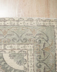 Selene Oriental Green Handmade Wool Rug, vibrant green wool rug with intricate oriental patterns, warmly lit in a living room setting.