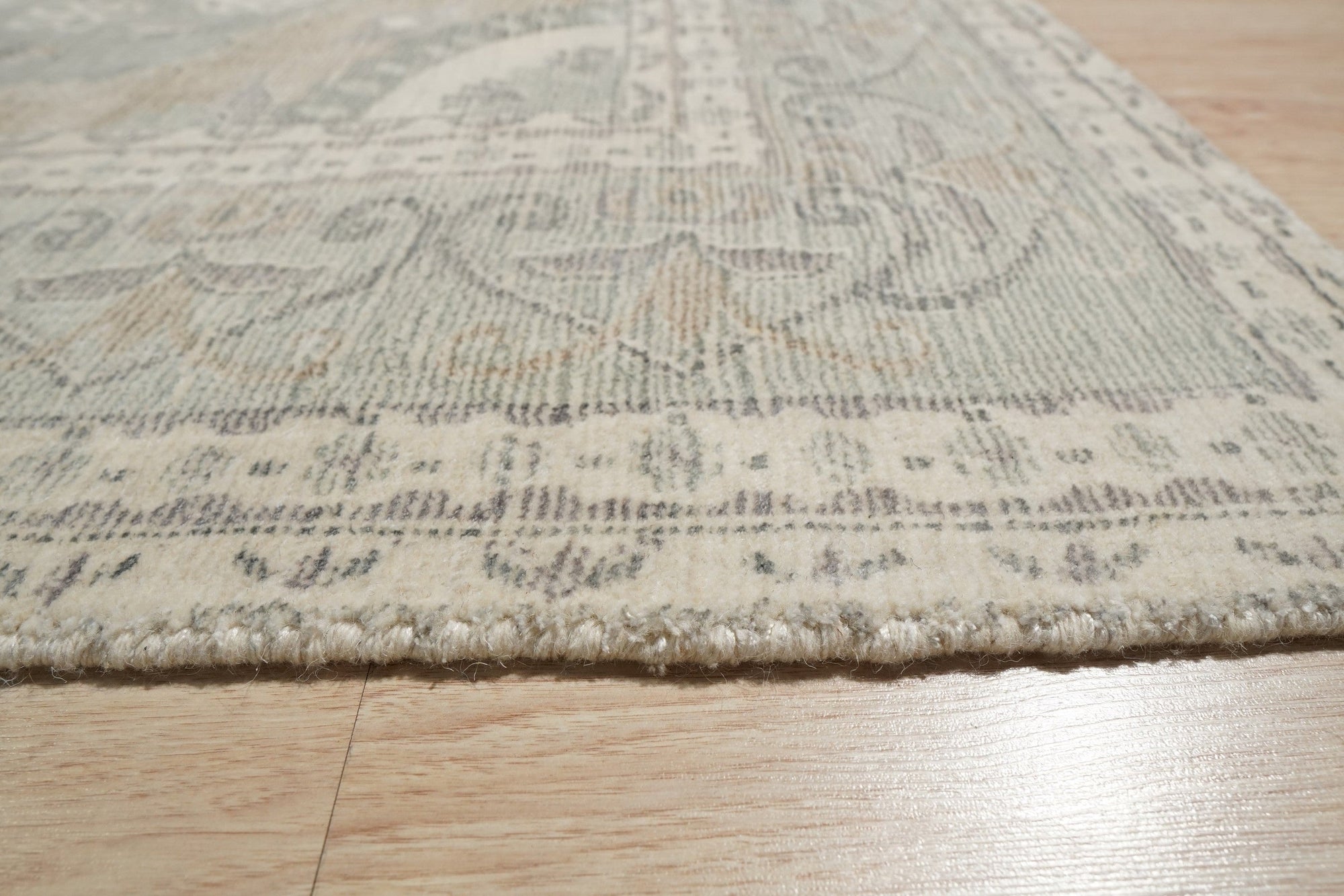 Selene Oriental Green Handmade Wool Rug, showcasing an intricate, earthy green oriental pattern; luxurious hand-knotted wool construction adds depth and texture to its lush pile.