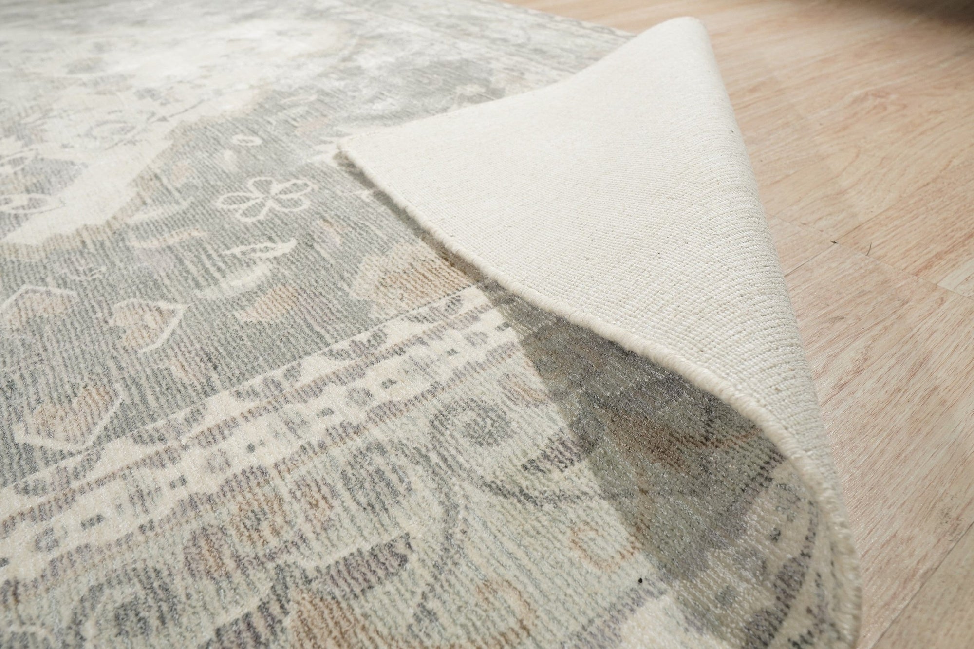 Selene Oriental Green Handmade Wool Rug, presenting a complex floral and geometric pattern in shades of green, cream, and rust, woven from wool with visible texture and intricate detailing.