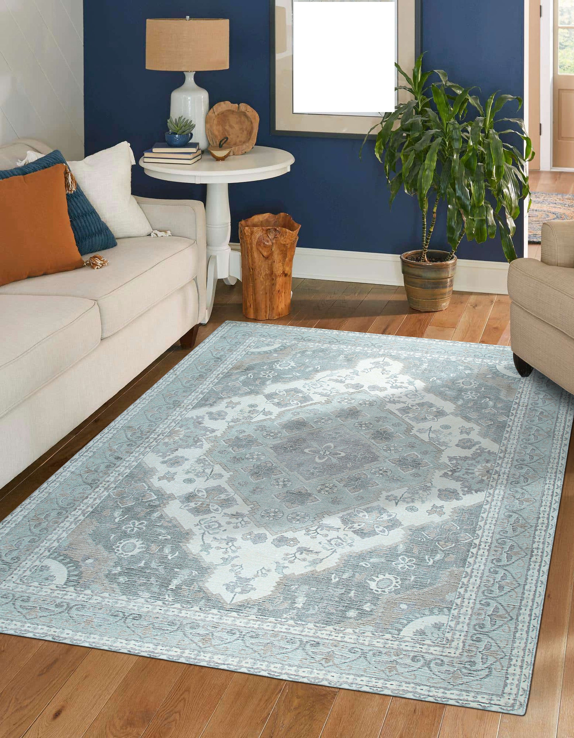 Selene Oriental Green Handmade Wool Rug, showcasing intricate floral patterns and borders in shades of green, cream, and gold, seen in a brightly lit room demonstrating its size and placement.