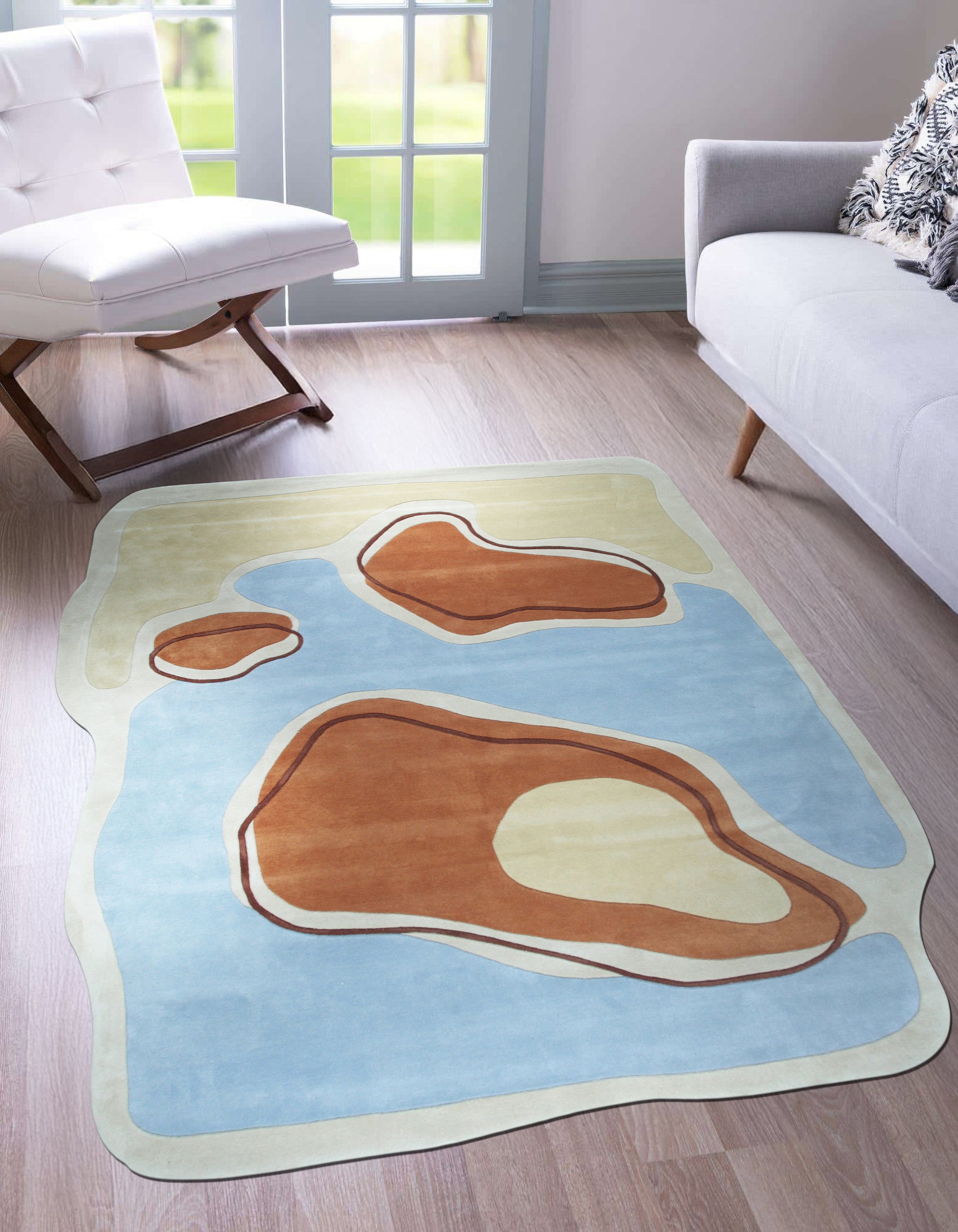 Yara Rustic Blue Hand Tufted Wool Rug, its cool blues and earthy tones grounding a contemporary living room with natural light and minimalist furniture.