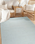 Handcrafted Artisan Ivory Hand Tufted Wool Rug, a luxurious ivory wool rug with a plush, hand-tufted texture, graces a softly lit living space, adding warmth and refined elegance to the room.
