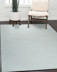 Handcrafted Artisan Ivory Hand Tufted Wool Rug, its plush ivory wool texture inviting bare feet in a bright, modern living room; a subtle geometric pattern adds depth to the neutral palette.