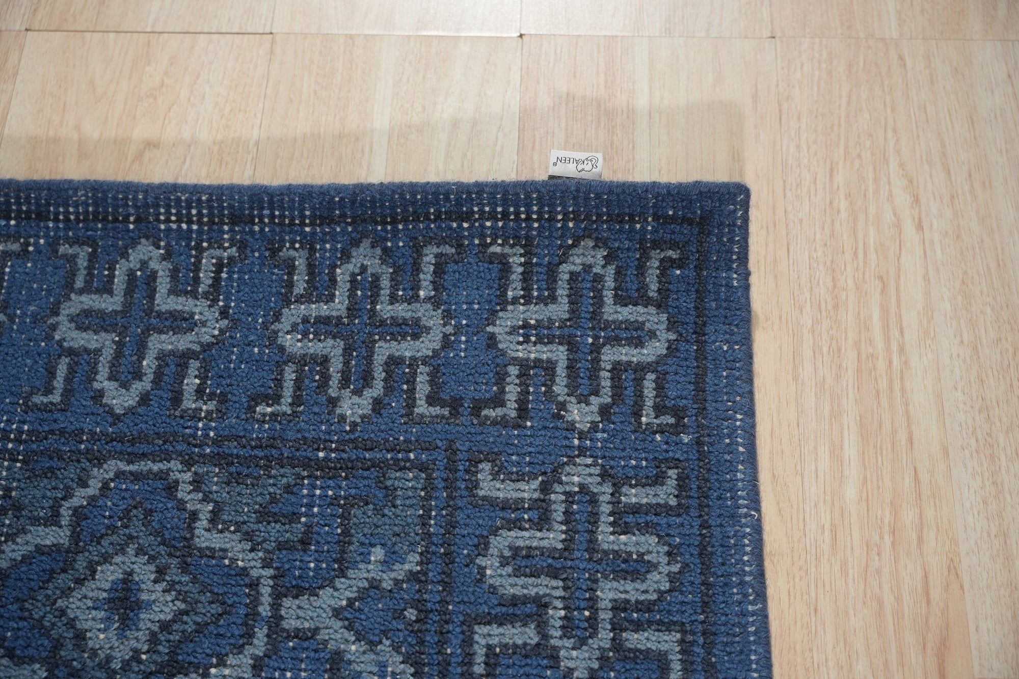 Mira Traditional Blue Hand Knotted Wool Rug, vibrant blues and intricate traditional patterns meet in this hand-knotted wool rug, showcasing its luxurious texture and detail.