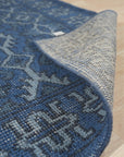 Mira Traditional Blue Hand Knotted Wool Rug, showcasing intricate floral and geometric motifs woven in deep blues and creams, displayed on a light wood floor.