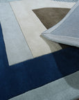 Bespoke Iris Multicolor Hand Tufted Wool Rug, vibrant floral patterns burst across a soft, hand-tufted wool surface, creating a welcoming atmosphere in a bright, modern living room.