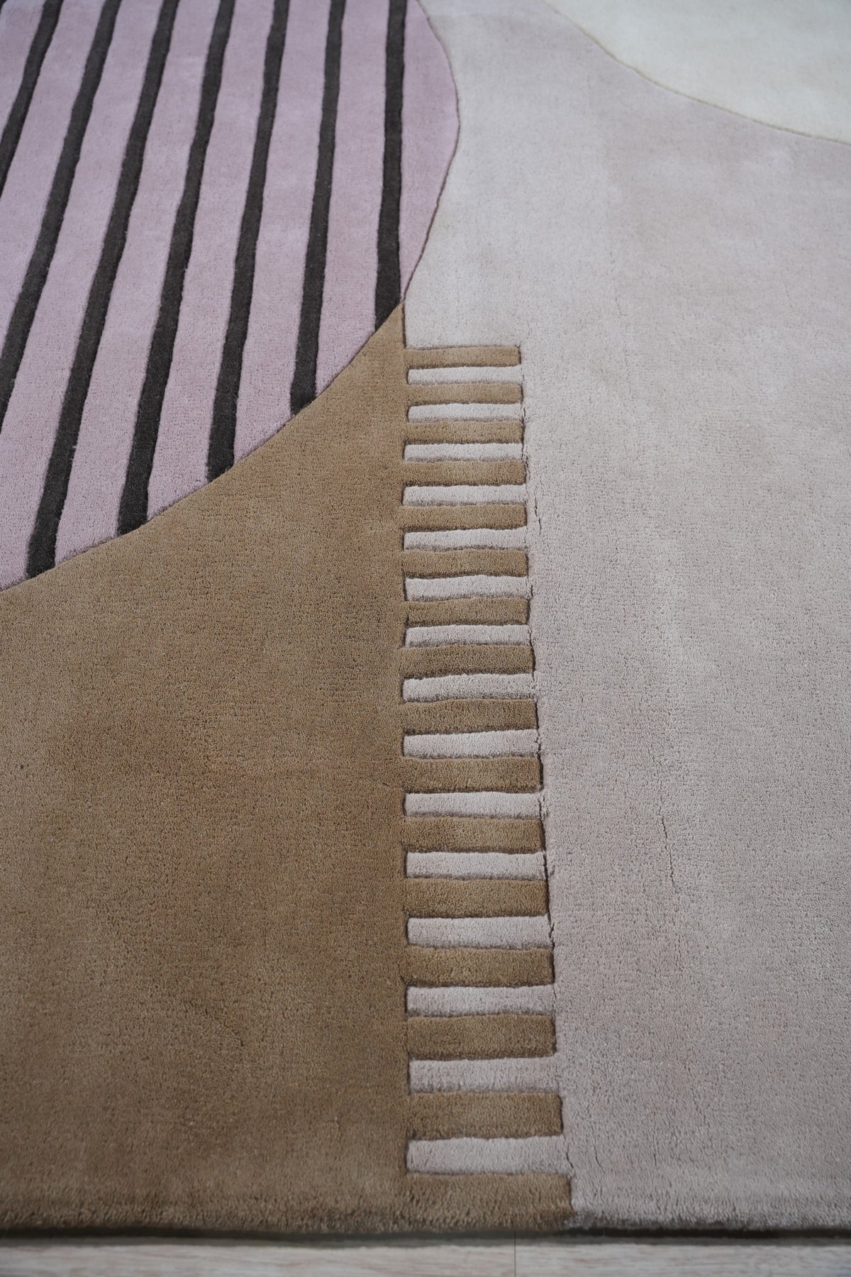 Bespoke Versatile Pink Hand Tufted Wool Rug partially visible, its soft pink hue complementing a light-filled space.