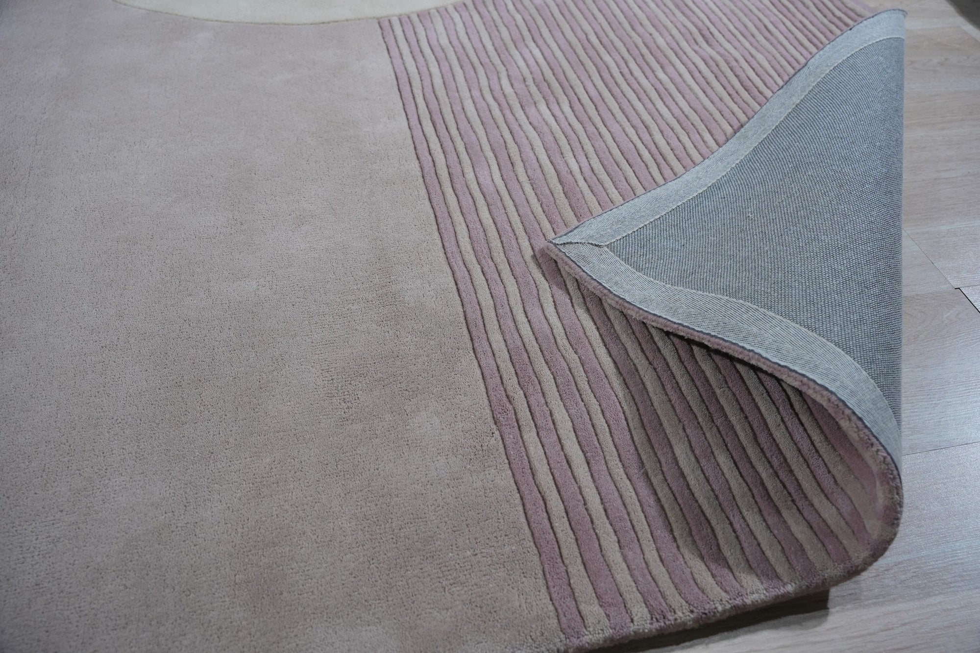 Bespoke Versatile Pink Hand Tufted Wool Rug, displayed in a bright living space, boasts a soft pink hue and plush wool texture, creating a warm and inviting atmosphere.