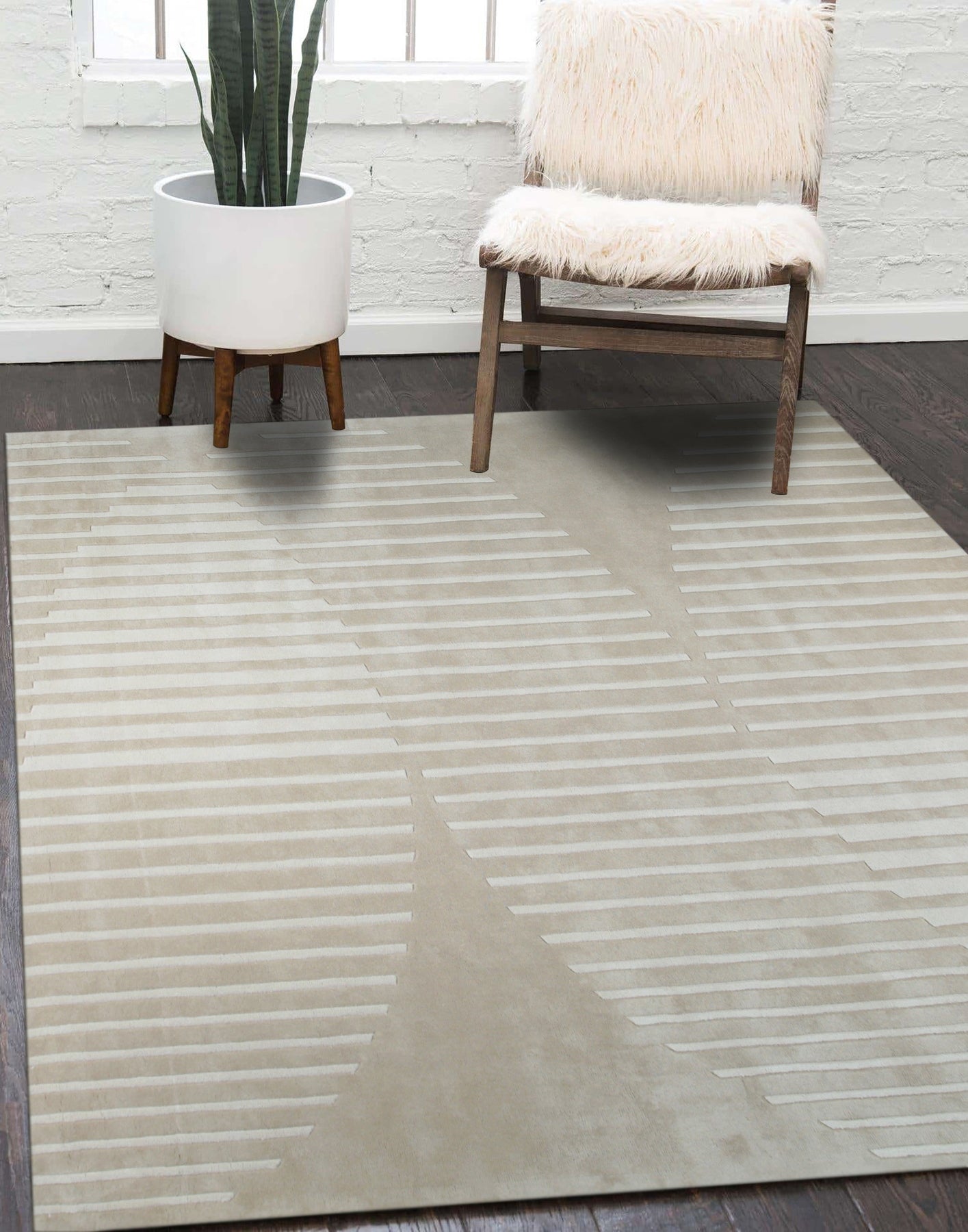 Maya Bianca Beige Hand Tufted Wool Rug, its soft beige hues and hand-tufted texture anchoring a bright, modern living room with natural light streaming through sheer curtains.