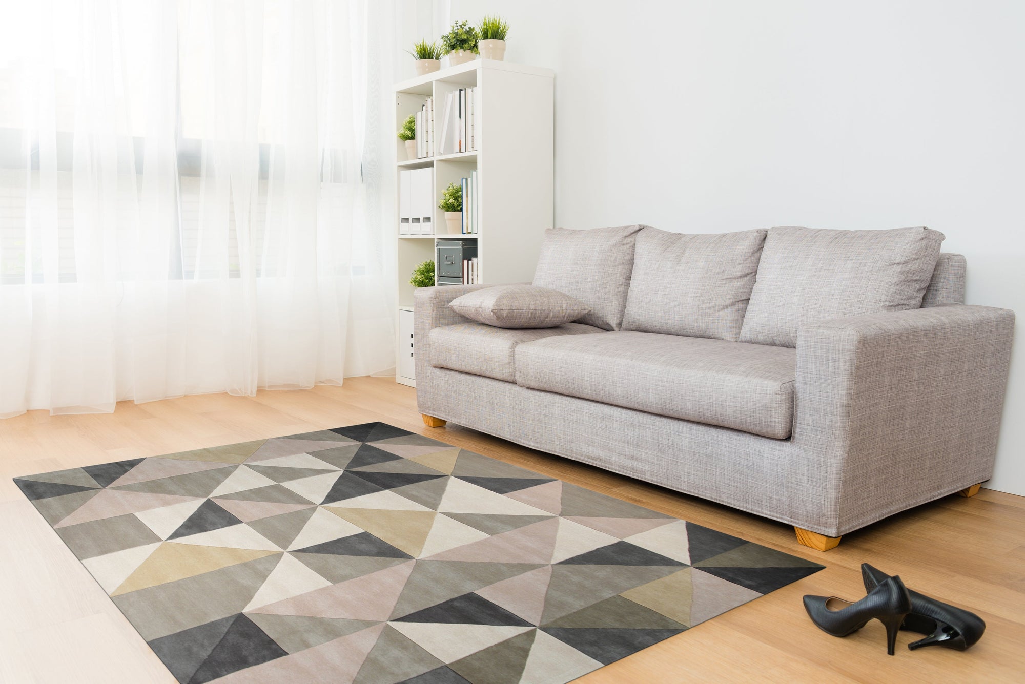 Trendy Classic Multicolor Hand Tufted Wool Rug displayed on a polished wooden floor, its vibrant hues and geometric patterns adding warmth to the space. Hand-tufted wool construction creates a plush texture.