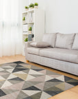 Trendy Classic Multicolor Hand Tufted Wool Rug displayed on a polished wooden floor, its vibrant hues and geometric patterns adding warmth to the space. Hand-tufted wool construction creates a plush texture.