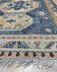 Luna Kilim Blue Hand Knotted Wool Rug, a blue wool rug featuring a geometric Kilim design, softly illuminated in a well-lit interior setting.