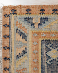 Luna Kilim Blue Hand Knotted Wool Rug, its geometric kilim patterns unfolding in shades of blue, accenting a softly lit interior.