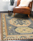 Luna Kilim Blue Hand Knotted Wool Rug, a striking geometric pattern of blues, creams, and terracotta tones across hand-knotted wool, displayed within a bright, modern living space.