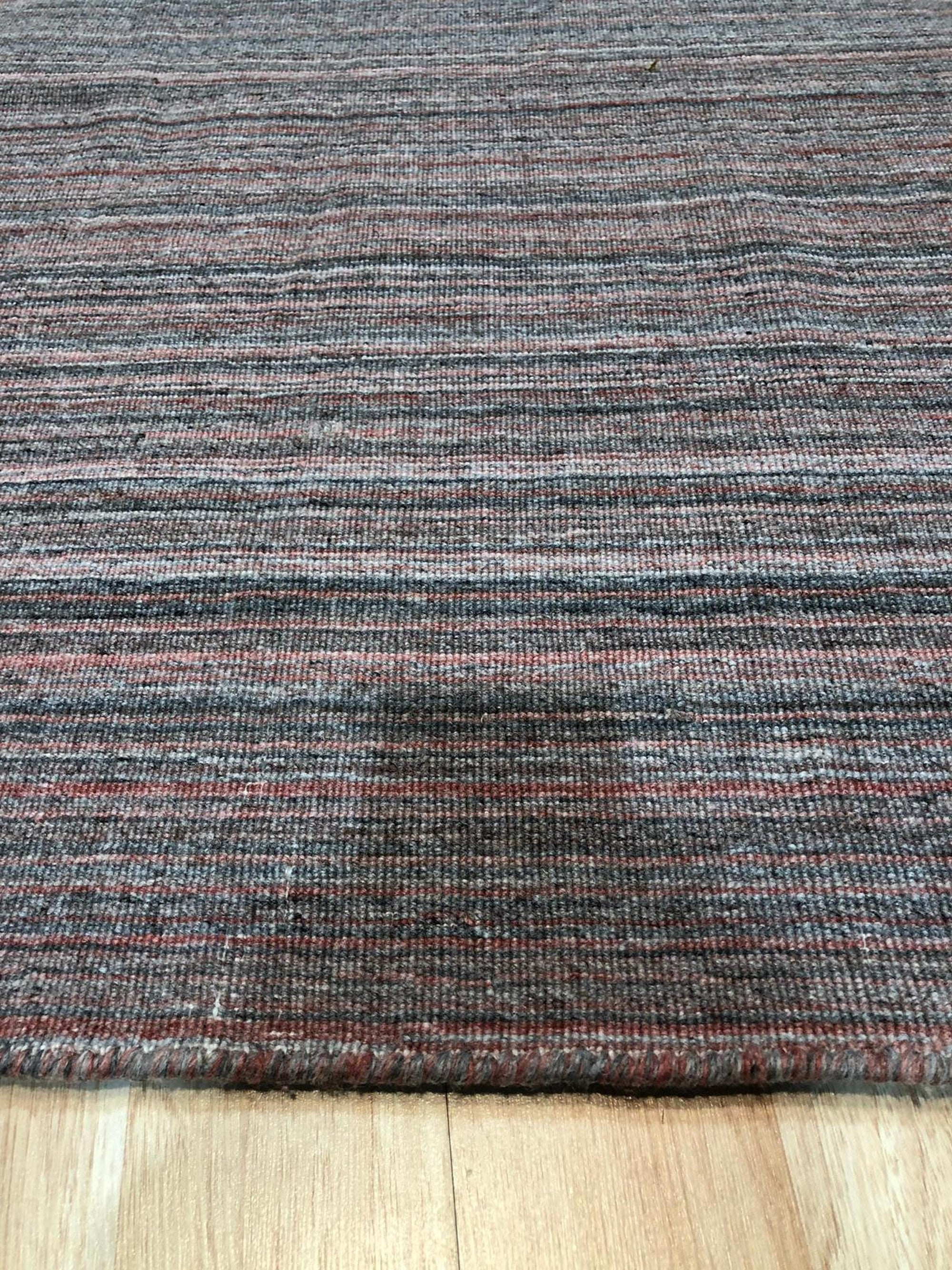 Artisan Striped Rust Handmade Rug, bringing warmth to a sunlit room; terracotta and cream stripes create a soft, inviting texture on this handcrafted rug.