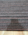 Artisan Striped Rust Handmade Rug, bringing warmth to a sunlit room; terracotta and cream stripes create a soft, inviting texture on this handcrafted rug.