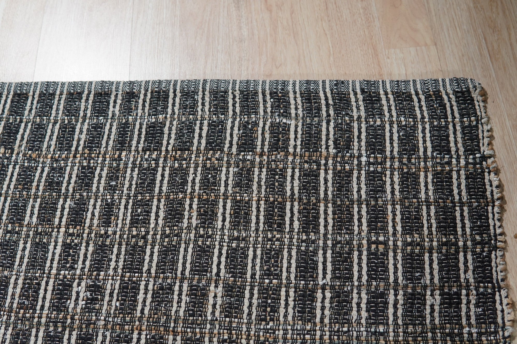 Lila Talia Gold Flatweave Rug, warm gold and ivory tones blend in a softly patterned flatweave, adding understated elegance to a sunlit room setting.