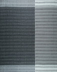 Isolated view showcasing the Clara Xena Charcoal Flatweave Wool & Cotton Rug's geometric pattern of intersecting lines in varying shades of charcoal and gray, revealing its flatweave texture.
