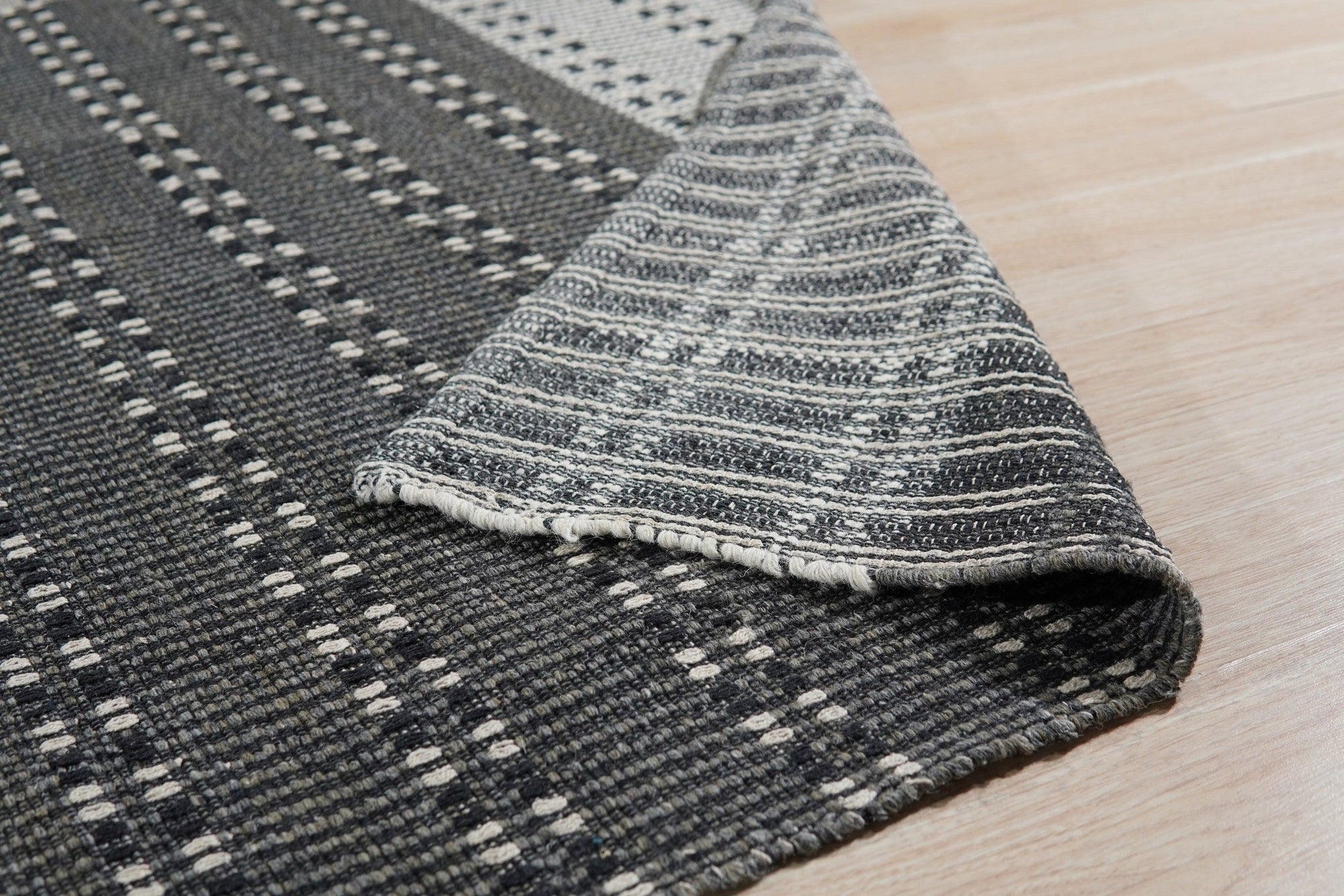 Clara Xena Charcoal Flatweave Wool & Cotton Rug, features a geometric design in varying shades of charcoal, flatwoven for a textural yet smooth feel.