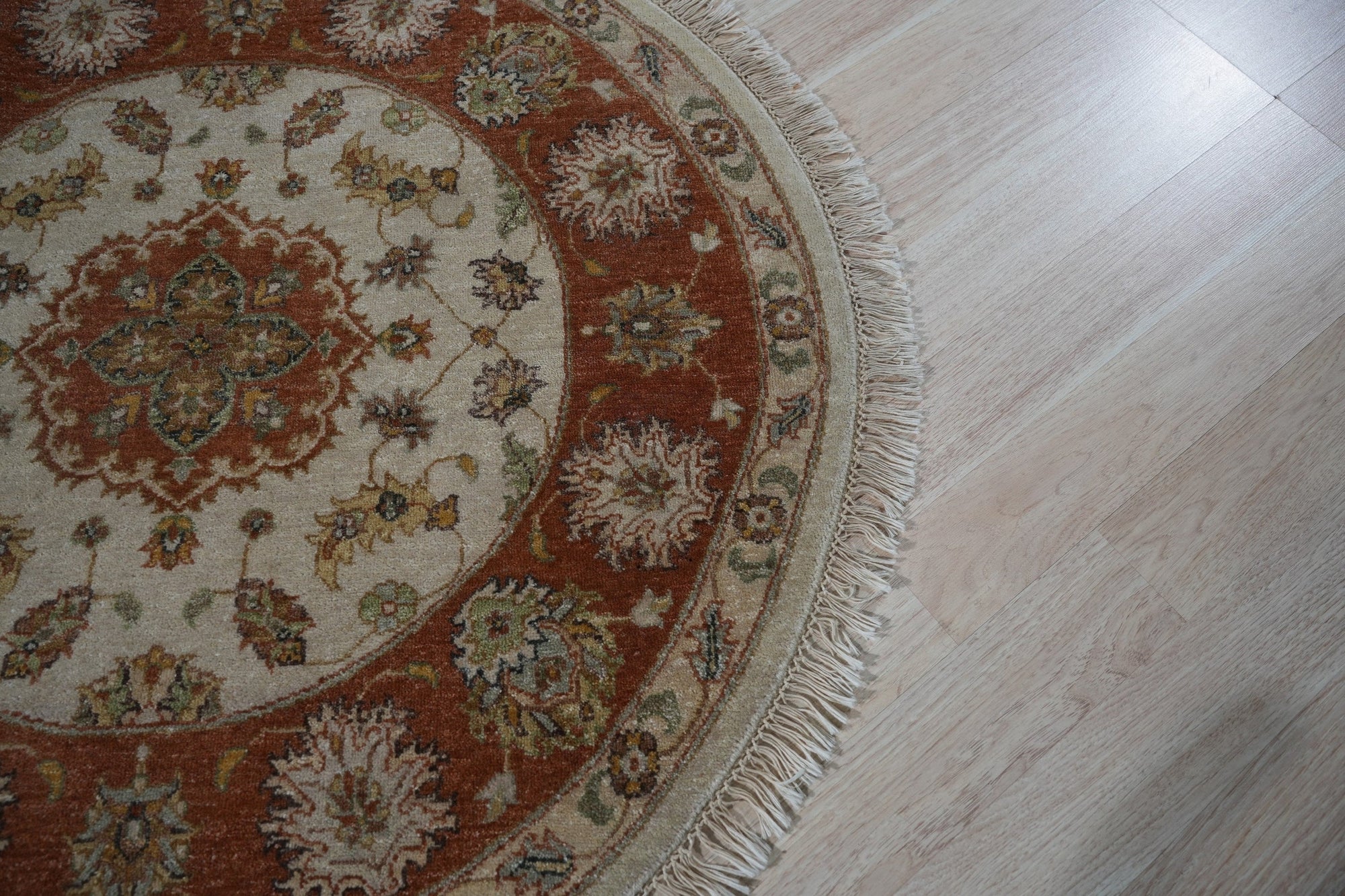 Celia Jasmine Ivory Hand Knotted Wool Rug, soft ivory tones and hand-knotted wool construction, displayed in a brightly lit interior with modern furniture.