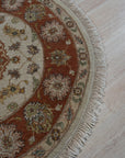 Celia Jasmine Ivory Hand Knotted Wool Rug, soft ivory tones and hand-knotted wool construction, displayed in a brightly lit interior with modern furniture.