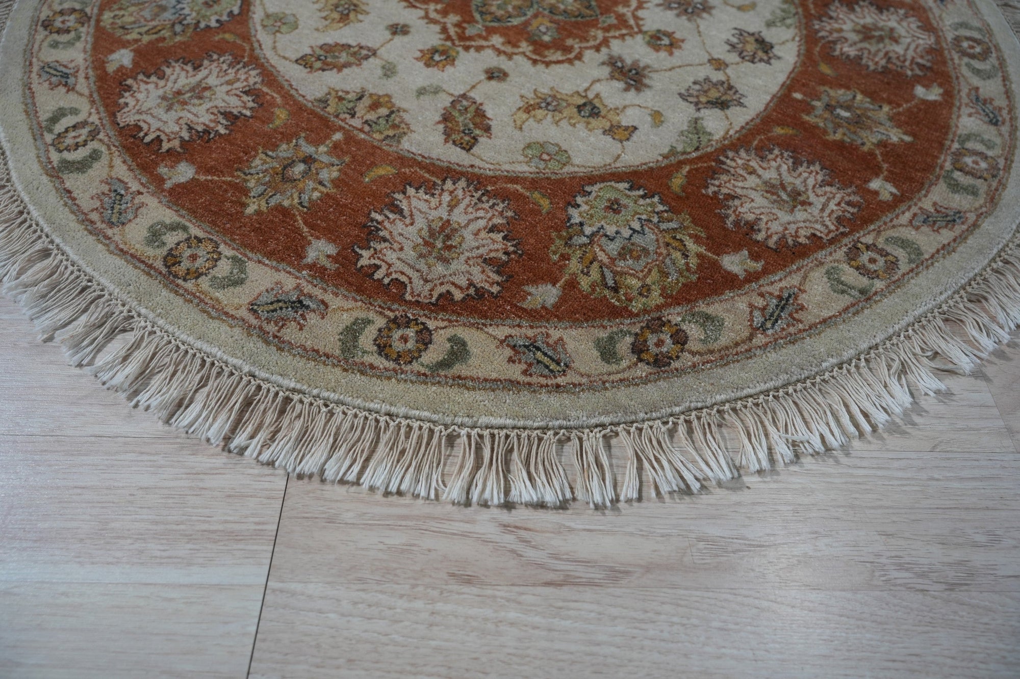 Celia Jasmine Ivory Hand Knotted Wool Rug, its intricate floral pattern unfolding across a room scene, showcasing the soft ivory tones and luxurious wool texture.