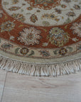 Celia Jasmine Ivory Hand Knotted Wool Rug, its intricate floral pattern unfolding across a room scene, showcasing the soft ivory tones and luxurious wool texture.