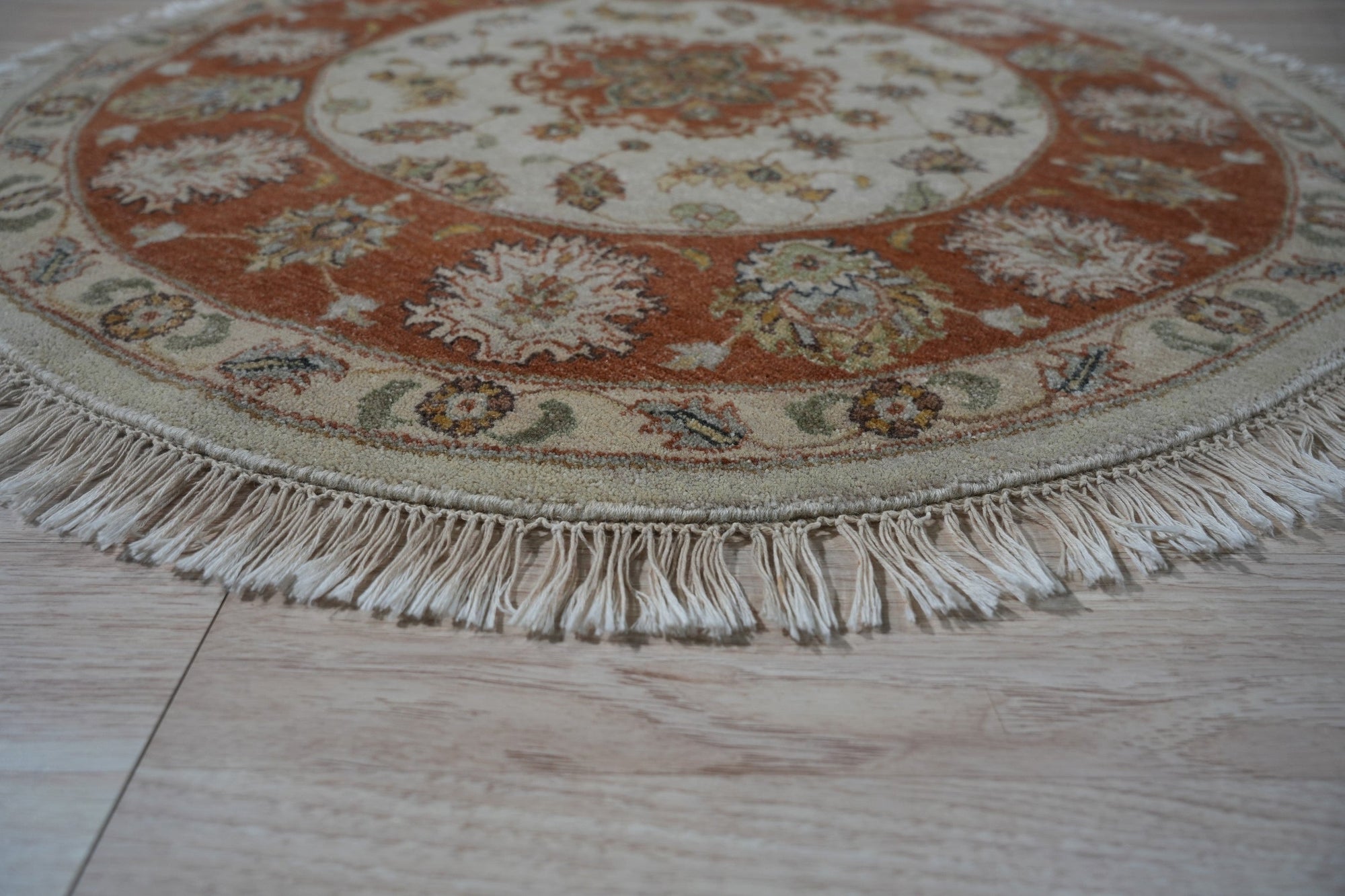 Celia Jasmine Ivory Hand Knotted Wool Rug, its creamy ivory tones and intricate hand-knotted details adding warmth to a bright, modern living room.