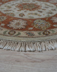 Celia Jasmine Ivory Hand Knotted Wool Rug, its creamy ivory tones and intricate hand-knotted details adding warmth to a bright, modern living room.