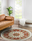 Celia Jasmine Ivory Hand Knotted Wool Rug, showcasing an intricate floral pattern in soft ivory tones, rests elegantly on a light hardwood floor, bathed in warm, natural light, inviting comfort and sophistication into the space.