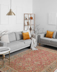 Celia Oushak Rust Hand Knotted Wool Rug, displaying intricate floral patterns in warm rust tones, hand-knotted for a luxurious texture, fills a brightly lit room with soft, diffused light.