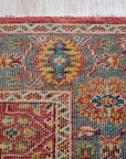 Celia Oushak Rust Hand Knotted Wool Rug, a warm rust and cream hand-knotted wool rug with a classic Oushak design, anchors a living space, its soft texture inviting bare feet.