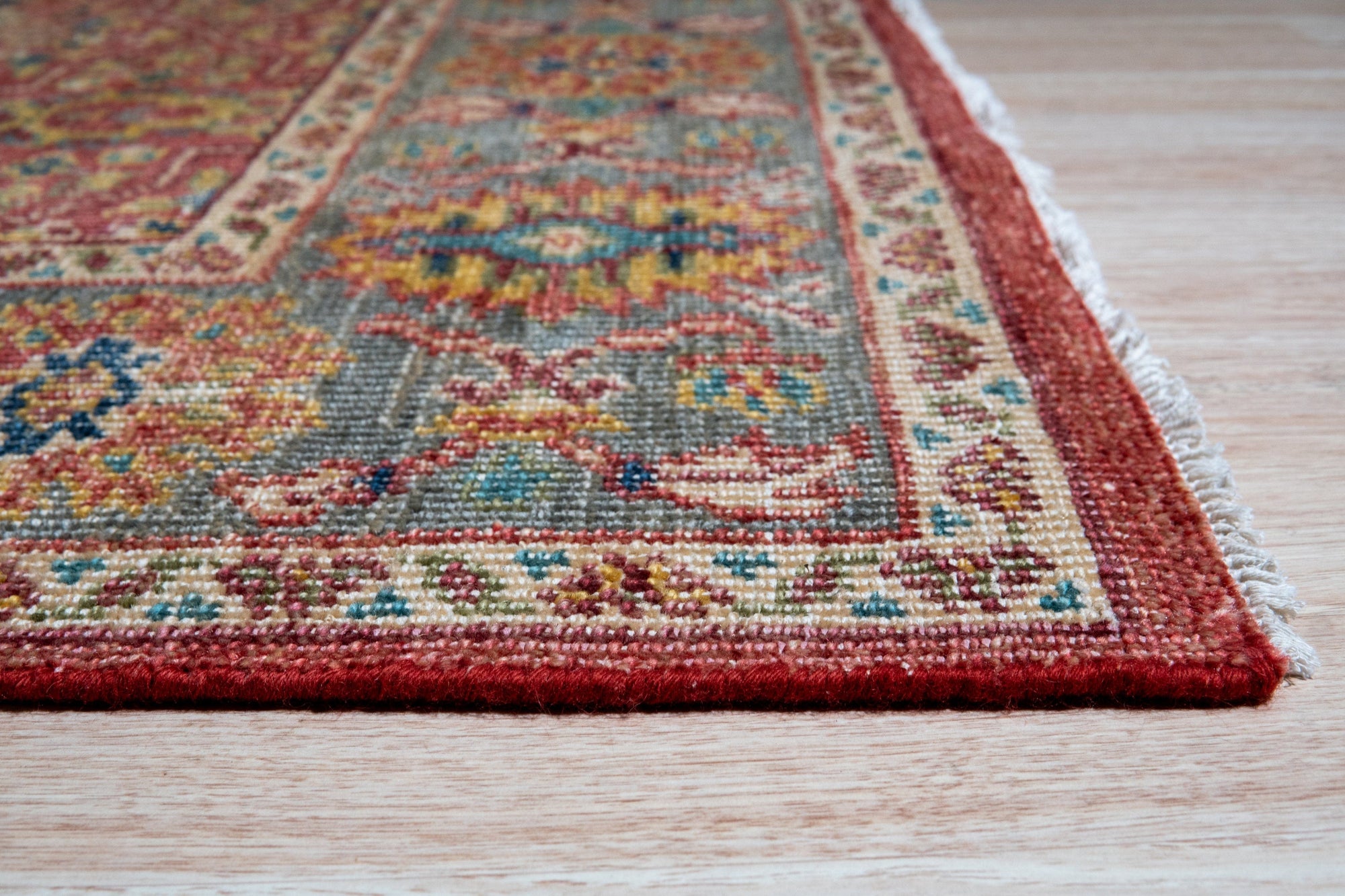 Celia Oushak Rust Hand Knotted Wool Rug, displays intricate floral medallions in warm rust and terracotta tones, its plush hand-knotted wool adding texture and depth to a light-filled room.