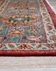 Celia Oushak Rust Hand Knotted Wool Rug, displays intricate floral medallions in warm rust and terracotta tones, its plush hand-knotted wool adding texture and depth to a light-filled room.