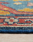 Comfortable Celia Blue Hand Knotted Wool Rug, a soothing blend of blues in a hand-knotted wool texture, creating a calming and sophisticated atmosphere in a living room setting.