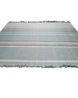 Opulent Majestic Blue Flatweave Wool Rug, showcasing its vibrant blue hues and intricate flatweave construction within a living room setting.