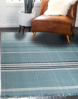 Opulent Majestic Blue Flatweave Wool Rug, a richly saturated blue wool rug with a geometric flatweave design, seen in a bright, modern interior setting.