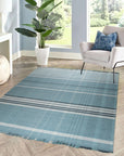 Opulent Majestic Blue Flatweave Wool Rug, its deep blue hues and flatweave construction grounding a modern living space with light wood floors and a comfortable grey sofa.