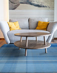 Maya Opulent Blue Flatweave Wool Rug displayed on a light hardwood floor, showcasing intricate geometric patterns in shades of blue, cream, and gray, highlighting the texture and flatweave construction.
