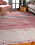 Maya Giselle Pink Flatweave Wool Rug displayed in a bright, modern living room setting. Soft pink hues and a subtle geometric pattern define this flatweave wool rug, grounding a seating area with a natural and inviting texture.