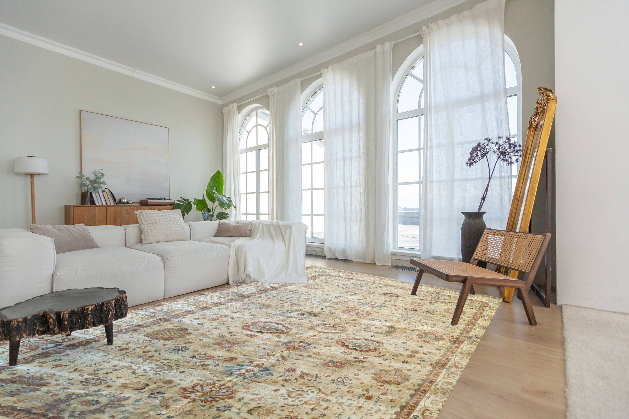 Versatile Agra Beige Hand Knotted Wool Rug displayed in a living room setting; light beige tones and intricate traditional patterns enrich the space's neutral palette.