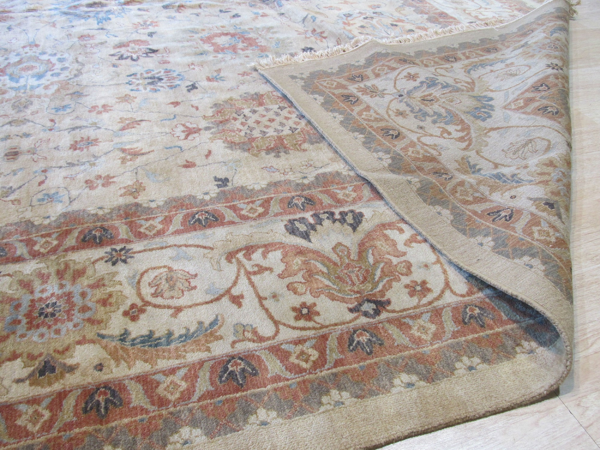 Versatile Agra Beige Hand Knotted Wool Rug, showcasing intricate hand-knotted details and soft beige hues, enhancing a room's texture and warmth.