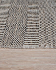 Trendy Dahlia Beige Handmade Wool Rug, a neutral expanse with subtle dahlia floral patterns, lending warmth and texture to a modern living space.