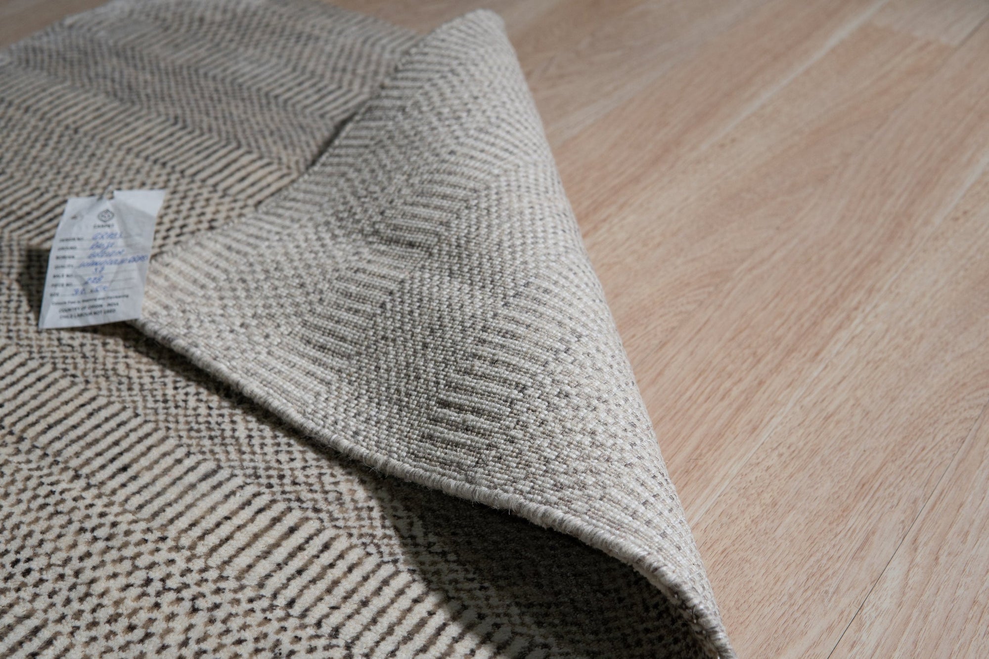 Trendy Dahlia Beige Handmade Wool Rug, soft beige wool underfoot, a modern floral dahlia pattern unfolds, crafted with a luxurious handmade feel, inviting warmth to any space.